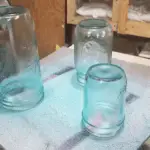 Painted glass jars after two coats of paint.