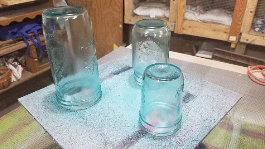 Painted glass jars after two coats of paint.