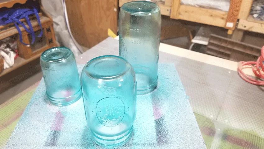 Spray painted glass jars after three coats of paint.