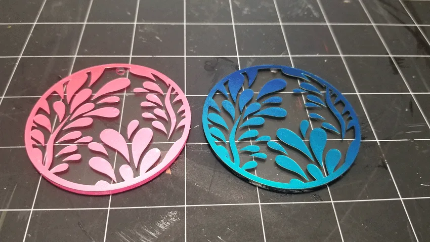 The background pieces weeded and applied to the acrylic keychain blanks.