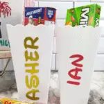 Close up of finished individual popcorn buckets with names.