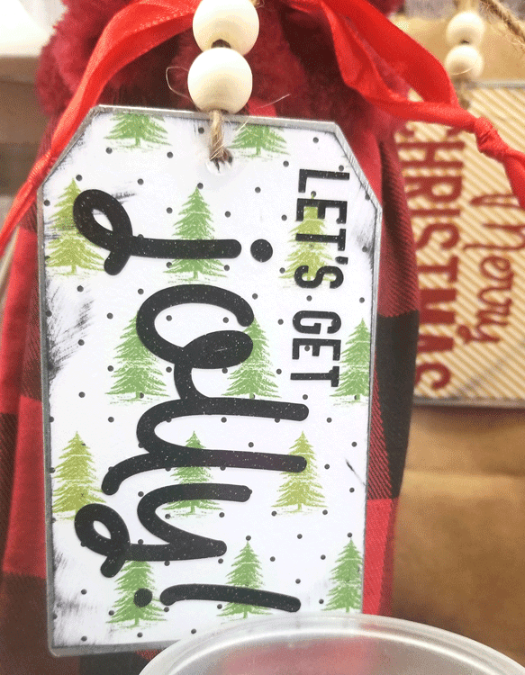 Finished metal gift tags decorated with holiday paper and glitter vinyl