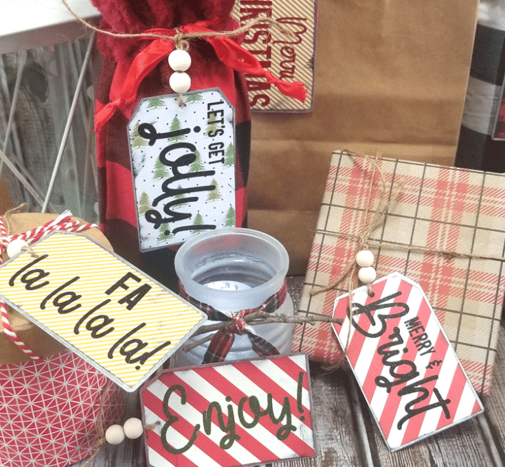 Finished metal gift tags decorated with holiday paper and glitter vinyl