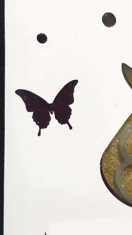 Close up of the final layer on the unicorn art piece with the cut butterfly and the transparent purple behind.