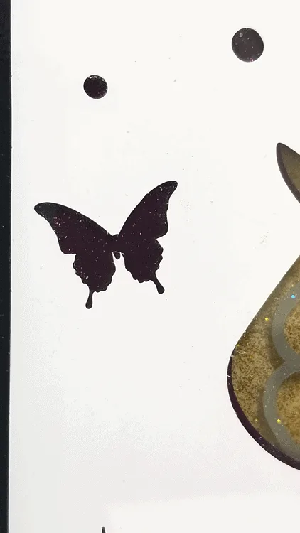 Close up of the final layer on the unicorn art piece with the cut butterfly and the transparent purple behind.
