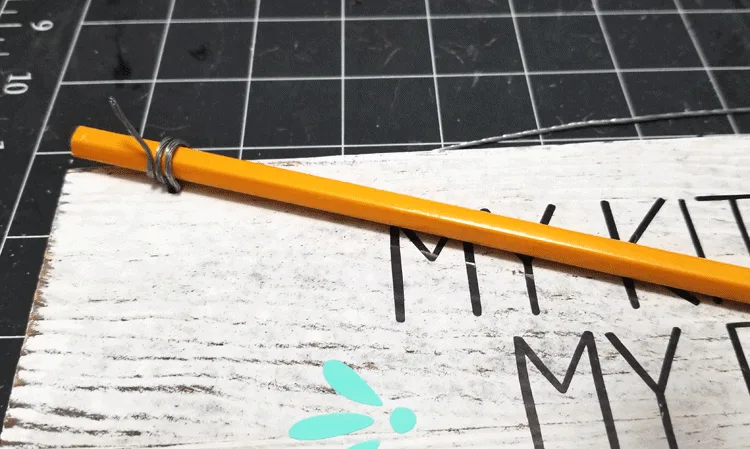 Using a pencil to twist the ends of the wire.