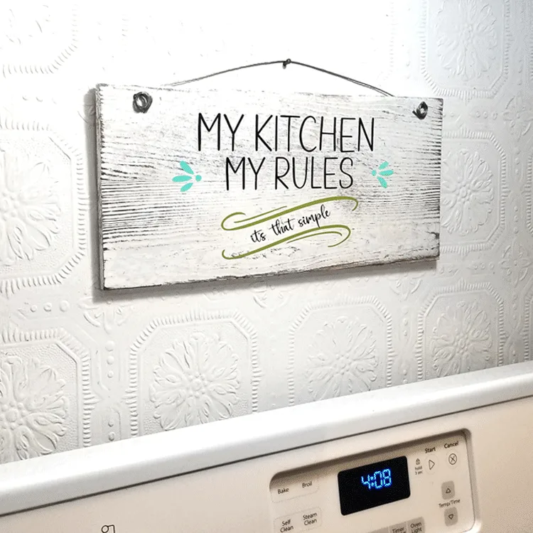 Finished easy kitchen rules sign hanging above the stove.